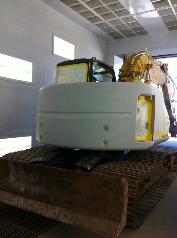 Backhoe being painted in the shop